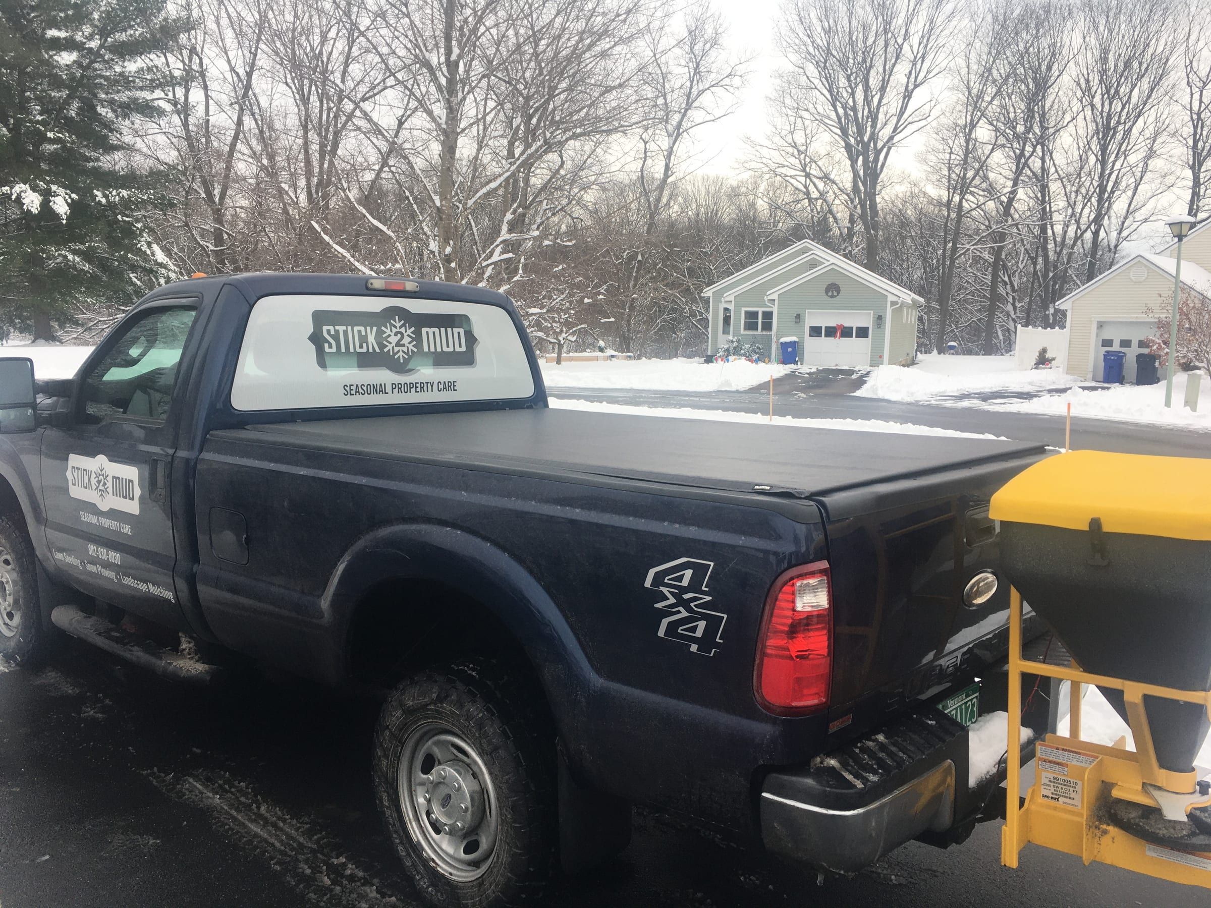 The Stick2Mud pickup with a salt spreader, in the snow